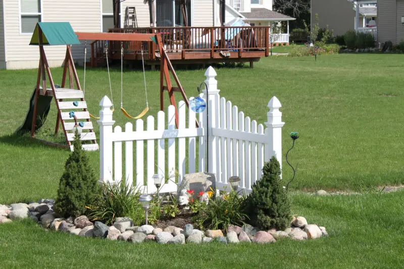 White fence garden installation backyard