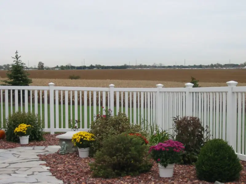 White fence with landscaped garden
