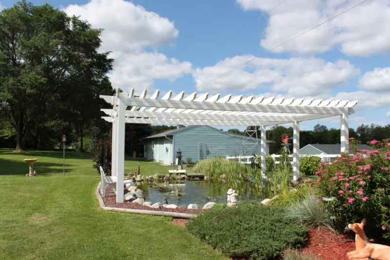White pergola backyard garden pond