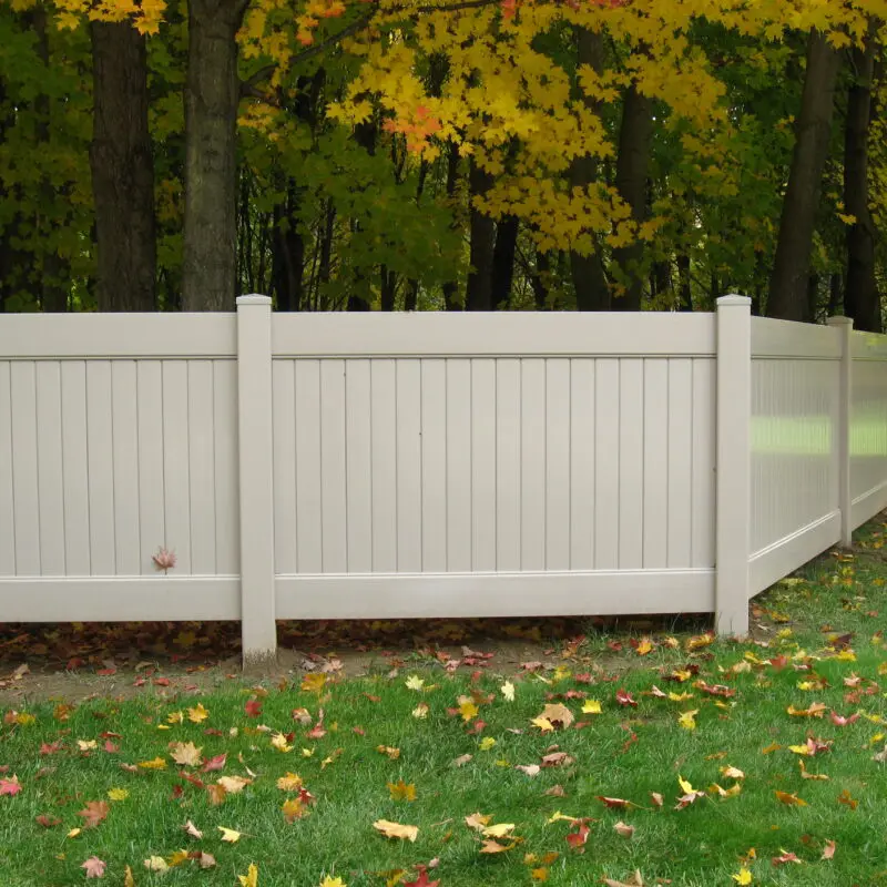 White PVC fence autumn leaves