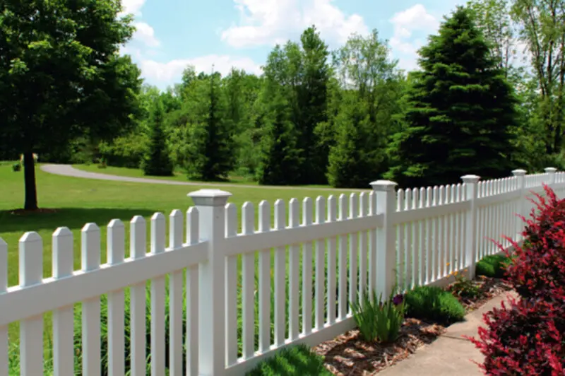 White picket fence lush greenery