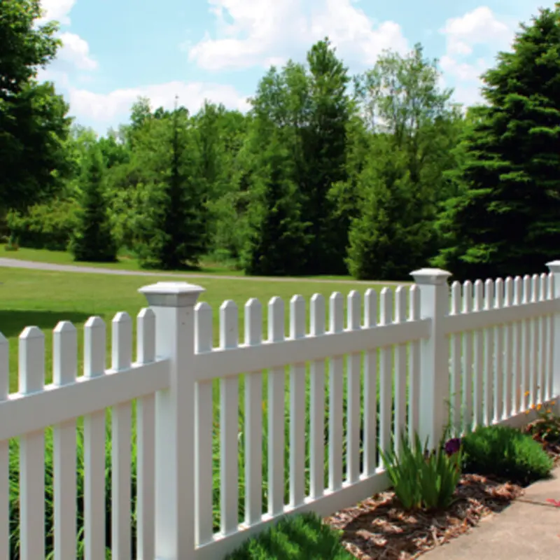 White picket fence lush greenery