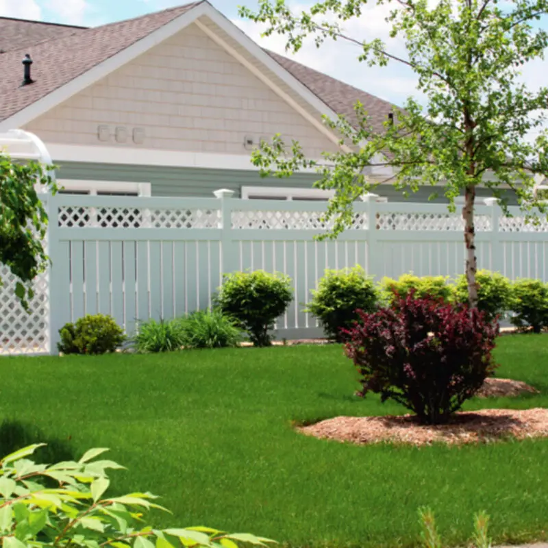 White fence lush green lawn