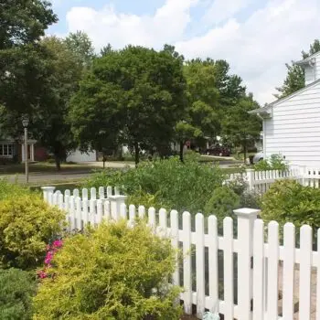 White picket fence surrounding garden