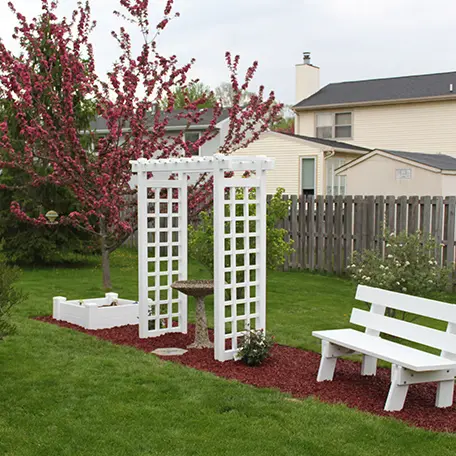 White arbor garden bench landscape