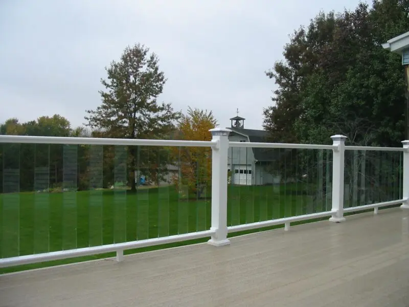 Glass railing overlooking green yard