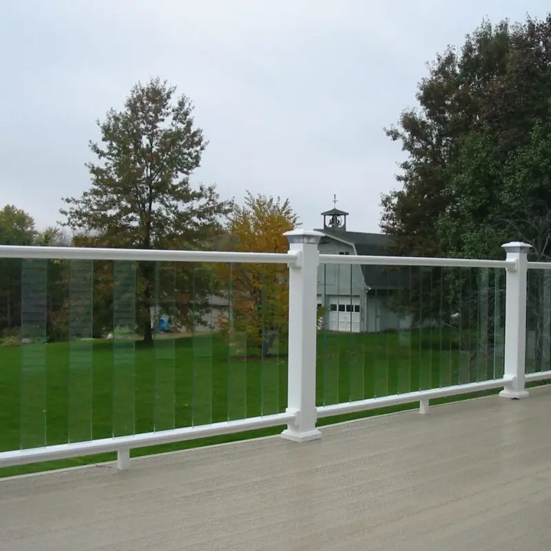 Glass railing overlooking green yard