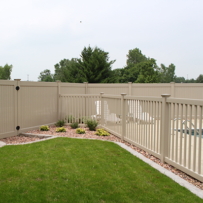 Outdoor beige fence with lawn